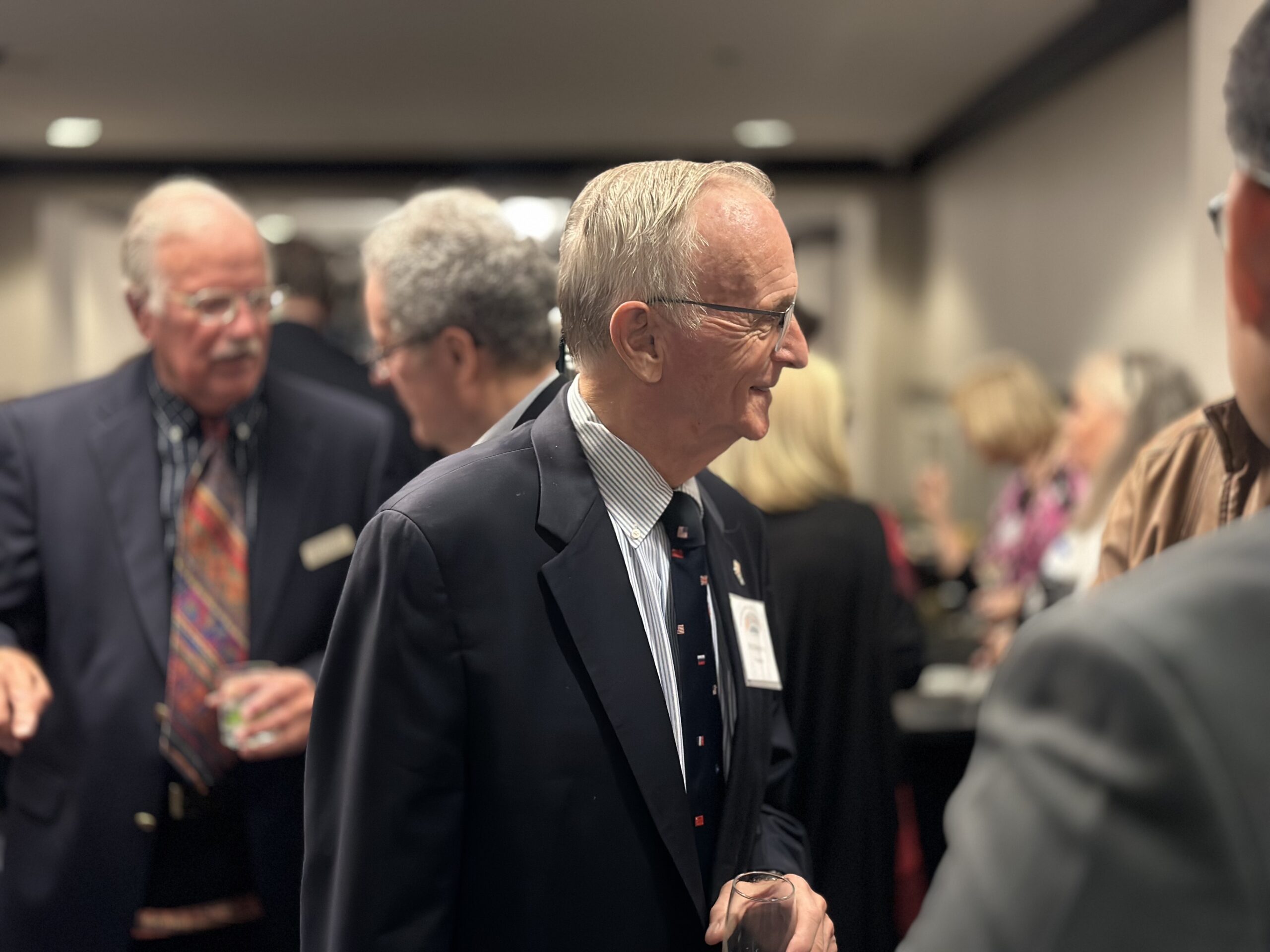 International Club of Annapolis President Phil Reynolds speaking with guests during the reception at the DoubleTree Hotel in Annapolis, Maryland.